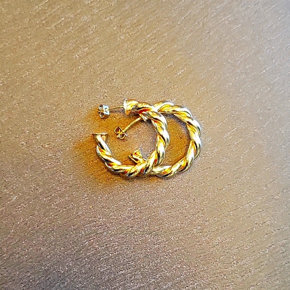 Gold twisted hoop earrings with post fixture